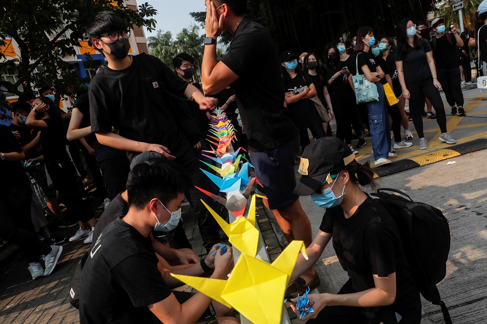 Alumni of Tsuen Wan Public Ho Chuen Yiu Memorial College arrange paper cranes at a student gathering in the school in solidarity with the student protester who was shot by a policeman in Tsuen Wan, Hong Kong October 2, 2019. — Reuters pic