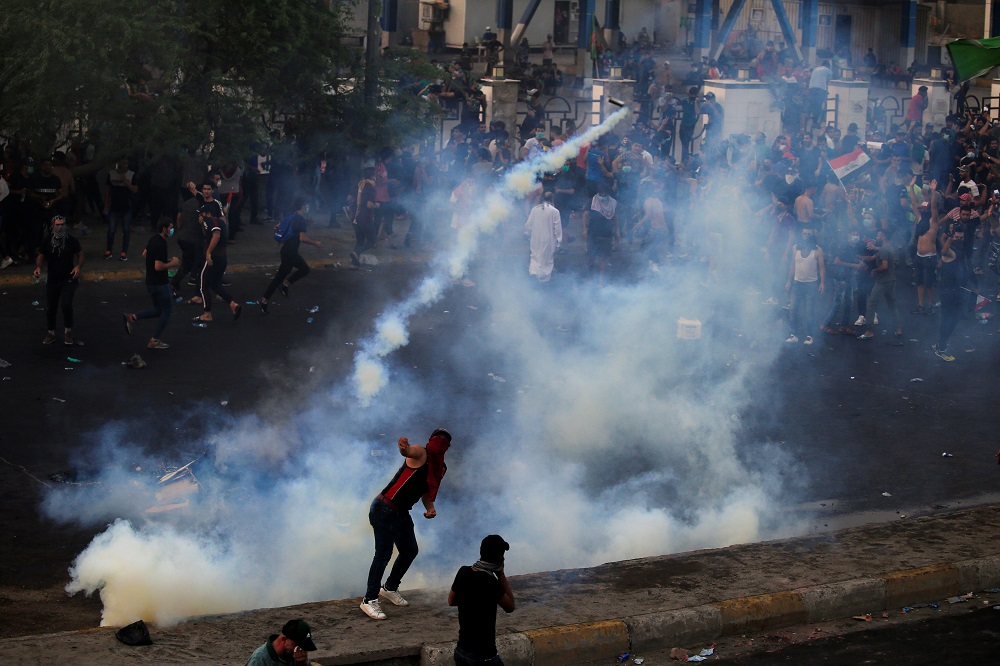 A demonstrator throws a tear gas canister used by Iraqi security forces as others disperse during a protest over unemployment, corruption and poor public services, in Baghdad October 2, 2019. u00e2u20acu201d Reuters pic