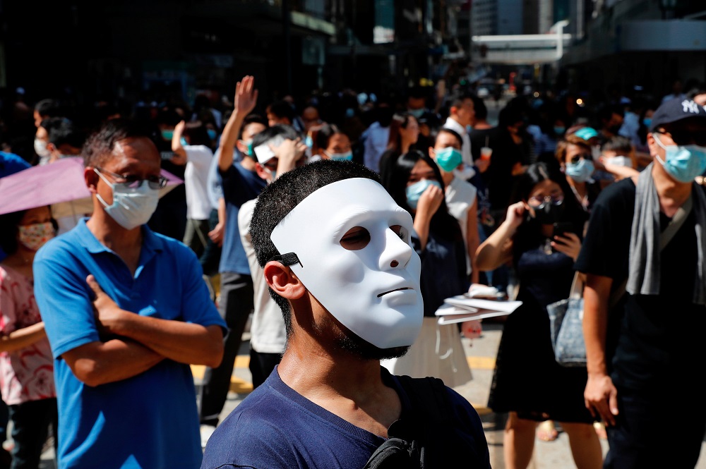 Anti-government office workers wearing masks attend a lunch time protest, after local media reported on an expected ban on face masks under emergency law, at Central, in Hong Kong October 4, 2019. — Reuters pic