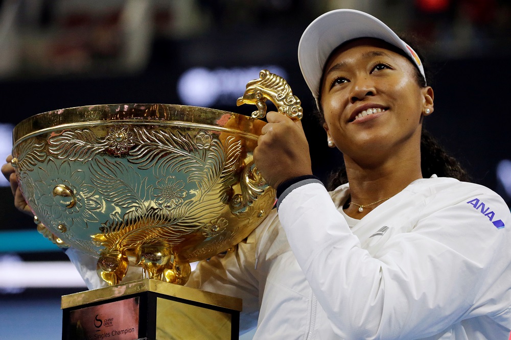 Naomi Osaka celebrates winning the China Open with her trophy at the National Tennis Centre in Beijing October 6, 2019. u00e2u20acu201d Reuters pic