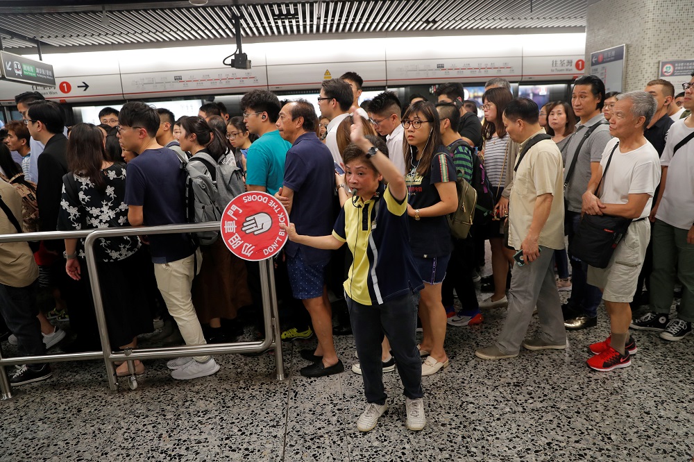 A woman directs people at Yau Ma Tei metro station, after the nearby Mong Kok was closed due to vandalism during protests, in Hong Kong October 9, 2019. u00e2u20acu201d Reuters pic