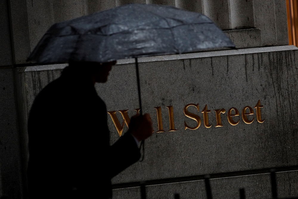 A man walks through the rain on Wall Street outside the New York Stock Exchange October 9, 2019. u00e2u20acu201d Reuters pic