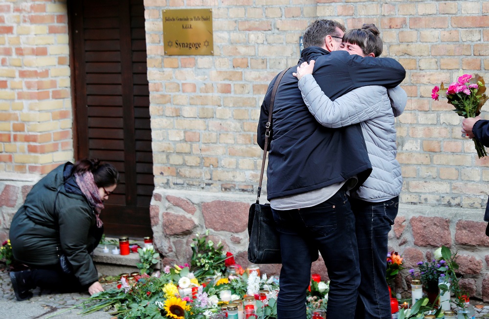People lay flowers as they mourn outside the synagogue in Halle, Germany October 10, 2019, after two people were killed in a shooting. u00e2u20acu201d Reuters pic