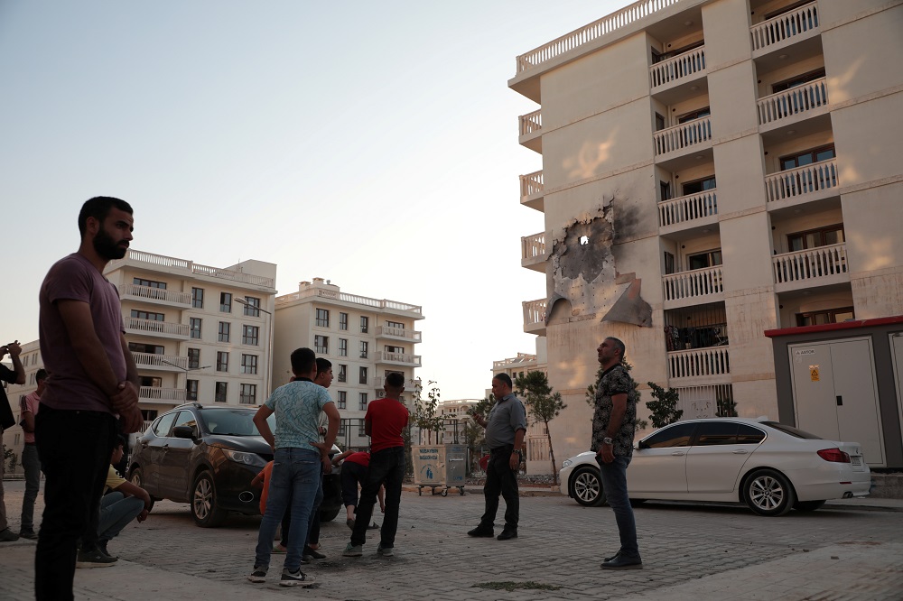 People stand in front of an apartment building which was damaged by a rocket fired from Syria, in Nusaybin, Turkey October 10, 2019. u00e2u20acu201d Reuters pic