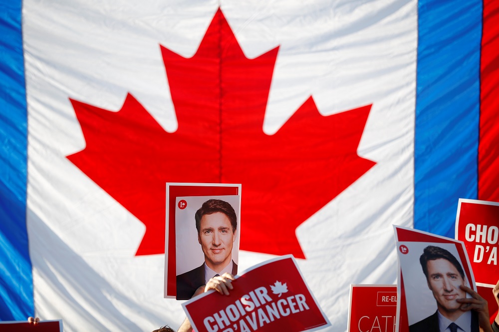 Supporters hold photographs of Liberal leader and Canadian Prime Minister Justin Trudeau as they gather before a French language federal election debate at the Canadian Museum of History in Quebec October 10, 2019. u00e2u20acu201d Reuters pic