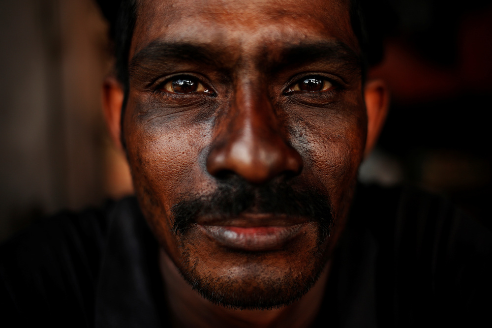 A Bangladeshi worker reacts to the camera as he takes a break at a tyre pyrolysis plant in Kulai, Johor August 7, 2019. — Reuters pic