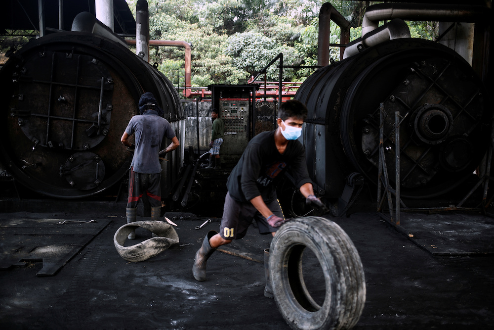Workers operate furnaces at a tyre pyrolysis plant in Kulai, Johor August 7, 2019. — Reuters pic