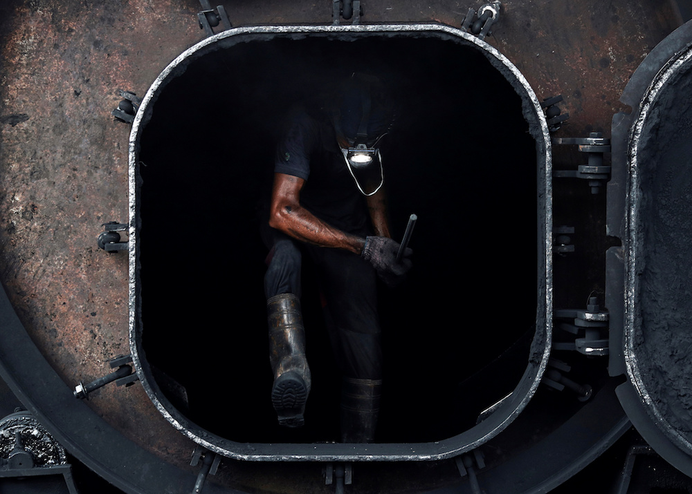 A Bangladeshi worker climbs out of a furnace at a tyre pyrolysis plant in Kulai, Johor August 7, 2019. — Reuters pic