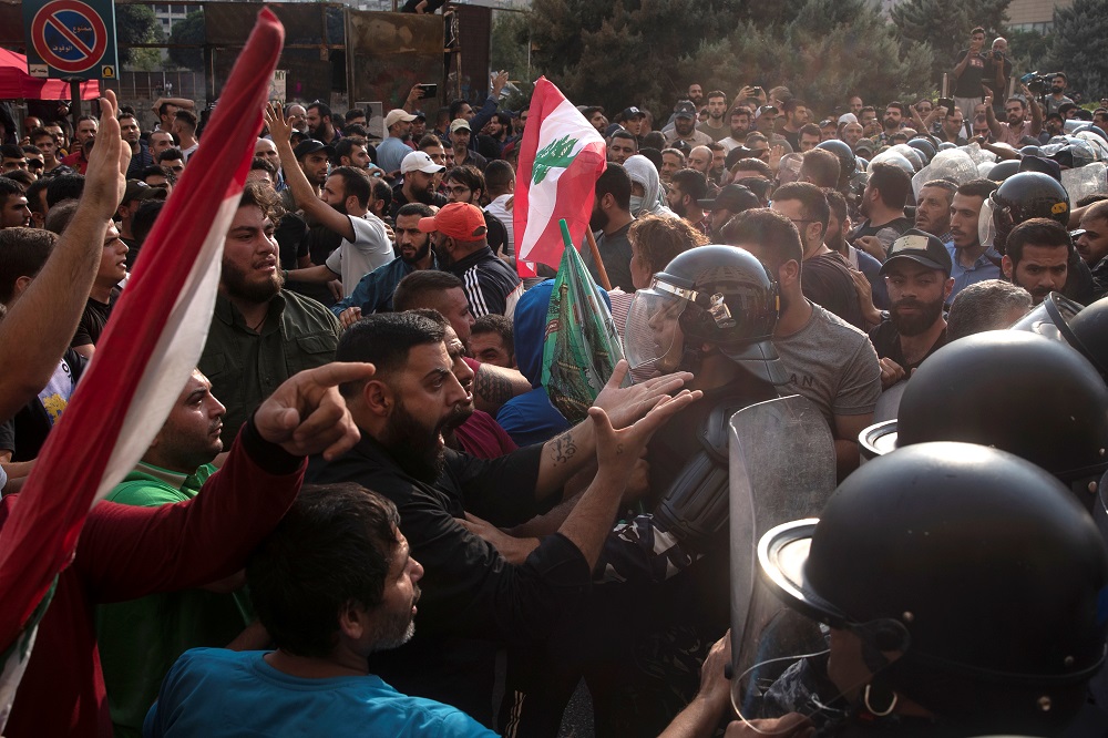 Riot police confront Hezbollah supporters during ongoing anti-government protests in downtown Beirut October 25, 2019. — Reuters pic