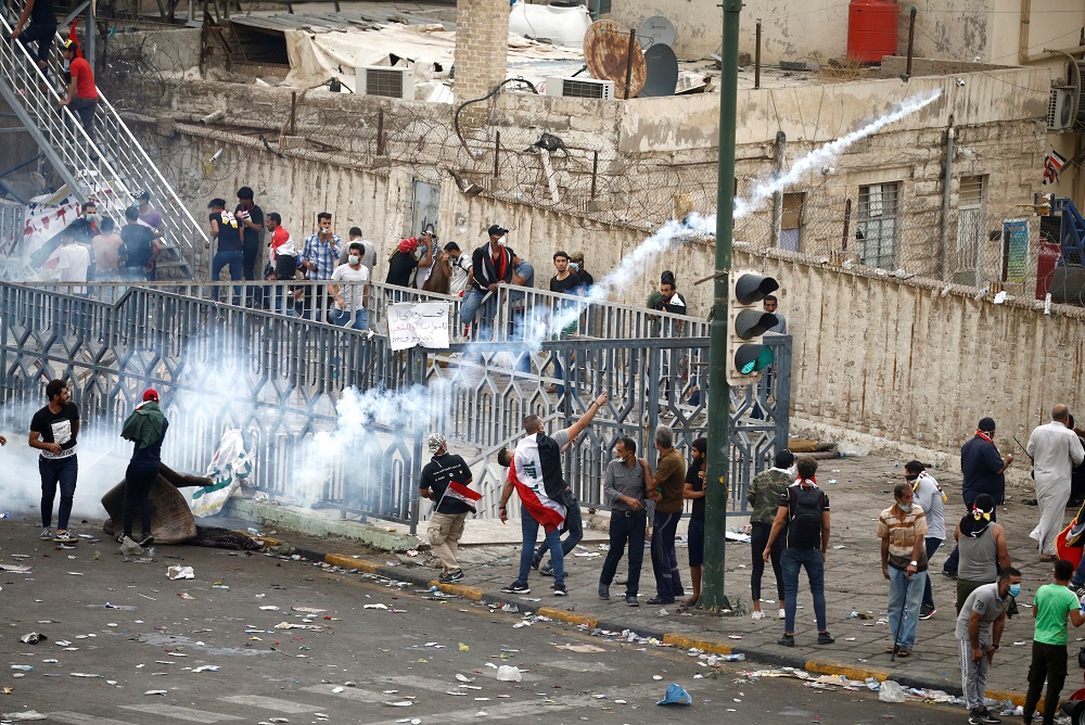 A demonstrator throws a tear gas canister during a protest over corruption, lack of jobs, and poor services, in Baghdad October 25, 2019. u00e2u20acu201d Reuters pic