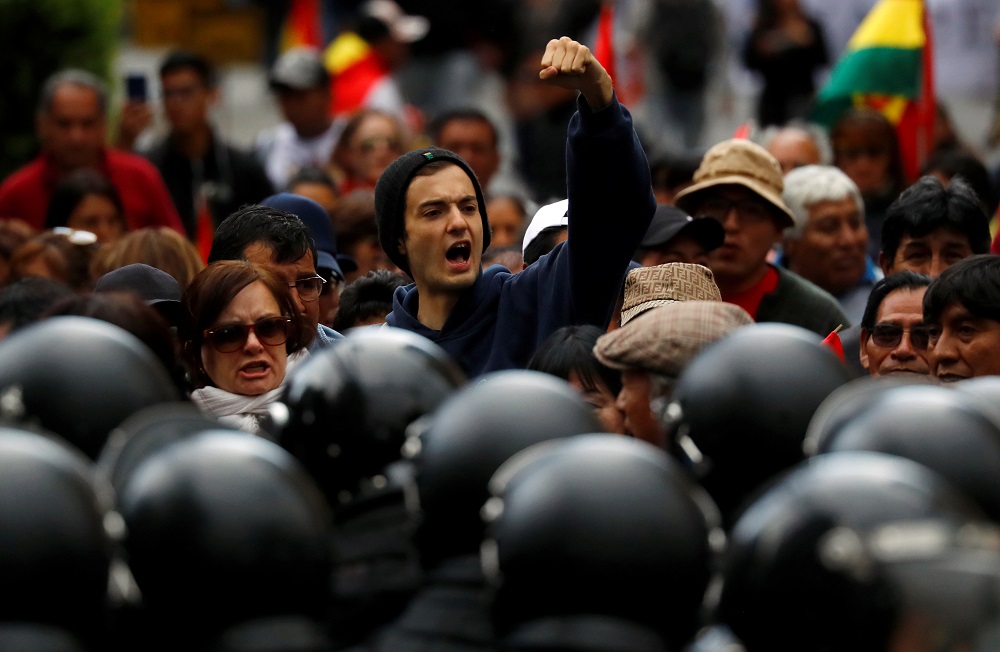 A protestor gestures in front of riot police during a march in La Paz, Bolivia October 25, 2019. — Reuters pic