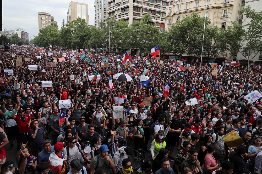 Demonstrators march with flags and signs during a protest against Chile's state economic model in Santiago October 25, 2019. u00e2u20acu201d Reuters pic
