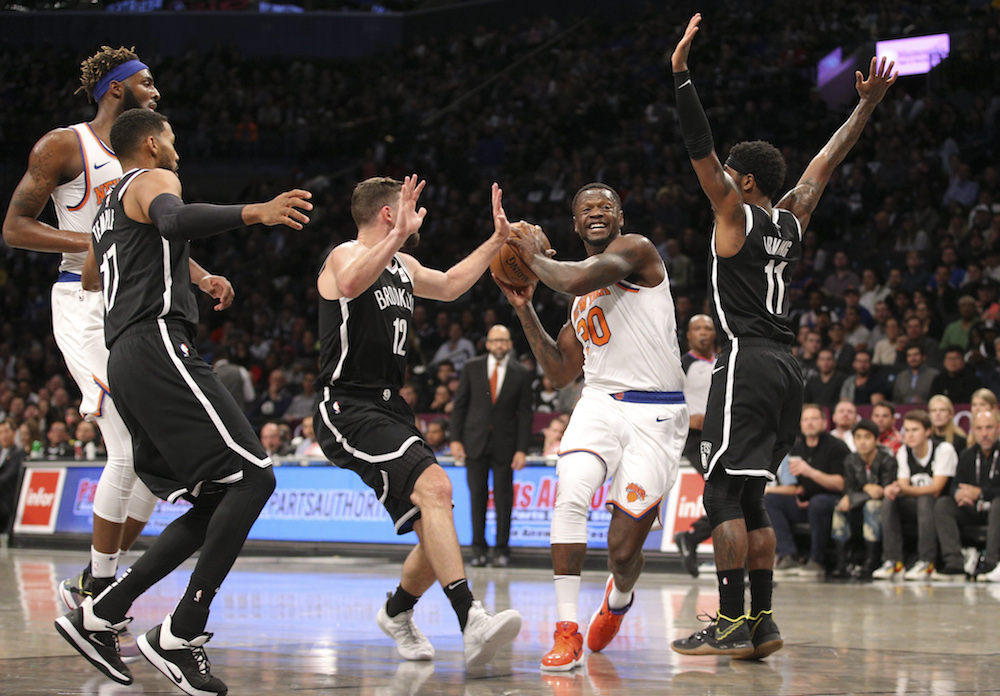New York Knicksu00e2u20acu2122 Julius Randle drives to the basket against Brooklyn Netsu00e2u20acu2122 Joe Harris and Kyrie Irving during the first quarter of the Battle of the Boroughs in New York October 25, 2019. u00e2u20acu201d Brad Penner-USA TODAY Sports pic via Reuters