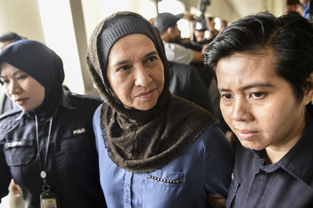Former Companies Commission of Malaysia (SSM) CEO, Datuk Zahrah Abd Wahab Fenner, is escorted by police at the Kuala Lumpur Sessions Court October 2, 2019. u00e2u20acu201d Picture by Miera Zulyana