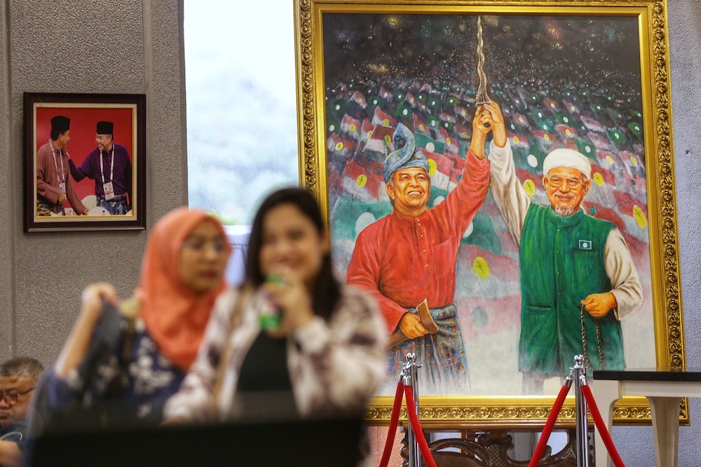 A painting depicting Umno president Datuk Seri Ahmad Zahid Hamidi and PAS president Datuk Seri Abdul Hadi Awang is seen at PWTC in Kuala Lumpur October 3, 2019. u00e2u20acu201d Picture by Ahmad Zamzahuri