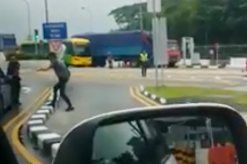 Chew Guan Mong (second from left) was arrested in January 2018, after he had a standoff with law enforcement and security personnel at Woodlands Checkpoint. u00e2u20acu201d Screen capture via Facebook