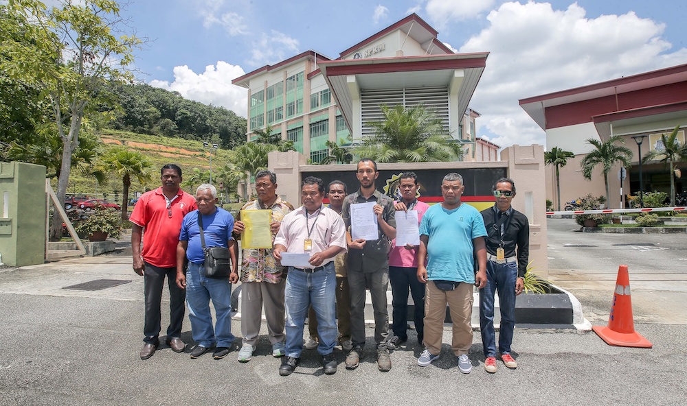 Representatives of 10 Orang Asli families from Jalong in Sungai Siput pose for pictures with copies of the report in front of the MACC office in Ipoh October 9, 2019. u00e2u20acu201d Picture by Farhan Najib