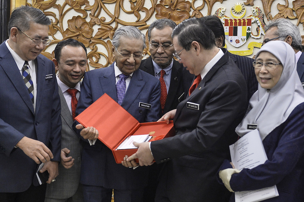 Prime Minister Tun Dr Mahathir Mohamad receives a copy of Budget 2020 from Finance Minister Lim Guan Eng in Parliament October 11, 2019. u00e2u20acu201d Picture by Miera Zulyana