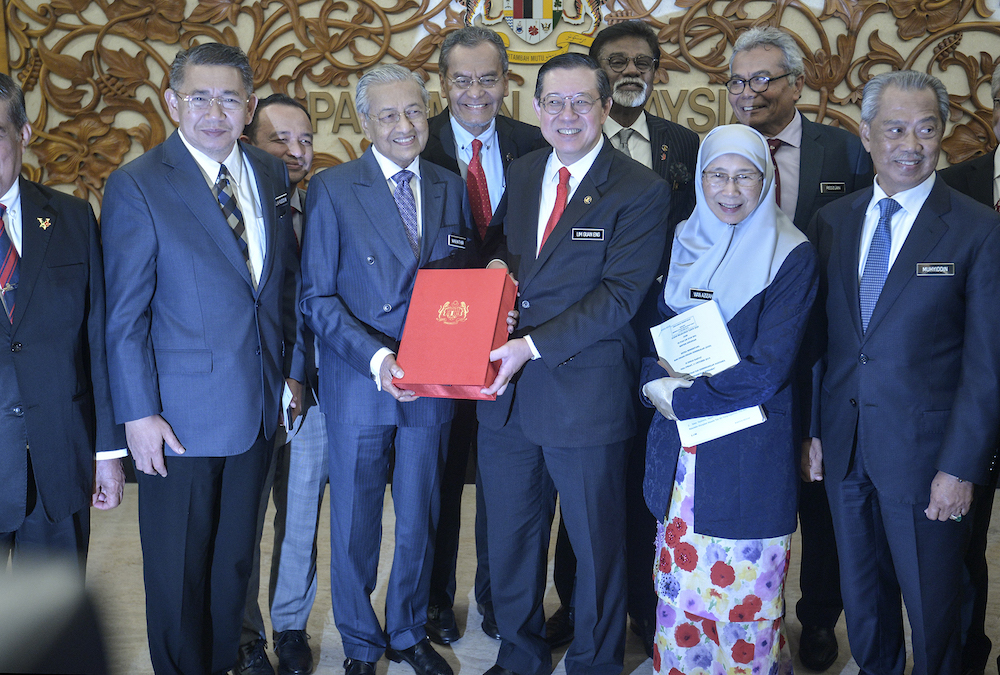 Prime Minister Tun Dr Mahathir Mohamad receives a copy of Budget 2020 from Finance Minister Lim Guan Eng in Parliament October 11, 2019. u00e2u20acu201d Picture by Shafwan Zaidon