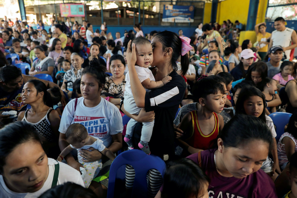 Mothers hold their children while waiting in line to receive free polio vaccine during a government-led mass vaccination program in Quezon City October 14, 2019. u00e2u20acu201d Reuters pic