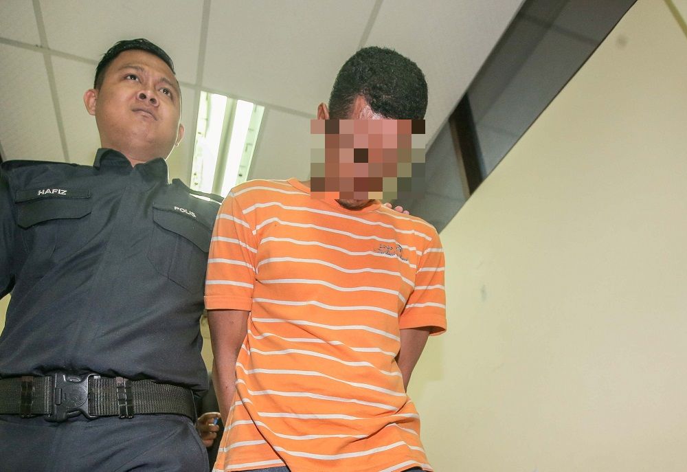 A 37-year-old fisherman is led out of court in handcuffs after being sentenced to 38 yearsu00e2u20acu2122 jail and 23 strokes of the rotan for raping his stepdaughter, in Ipoh October 17, 2019. u00e2u20acu201d Picture by Farhan Najib