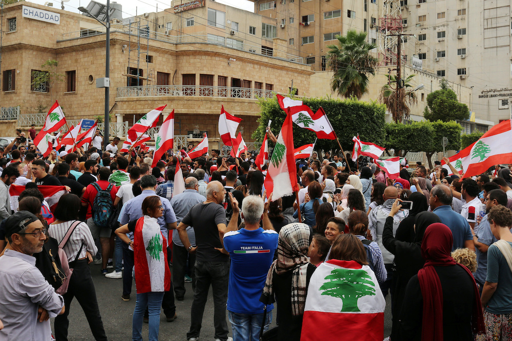 Demonstrators carry Lebanese flags during an anti-government protest near the central bank building in the southern city of Tyre, Lebanon October 23, 2019. u00e2u20acu201d Reuters pic