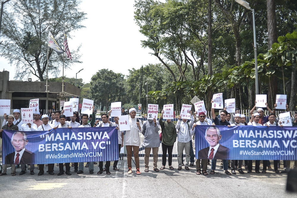 Universiti Malaya students hold placards and large banners in support of vice-chancellor Datuk Abdul Rahim Hashim during a protest at the university in Kuala Lumpur October 25, 2019. — Picture by Shafwan Zaidon