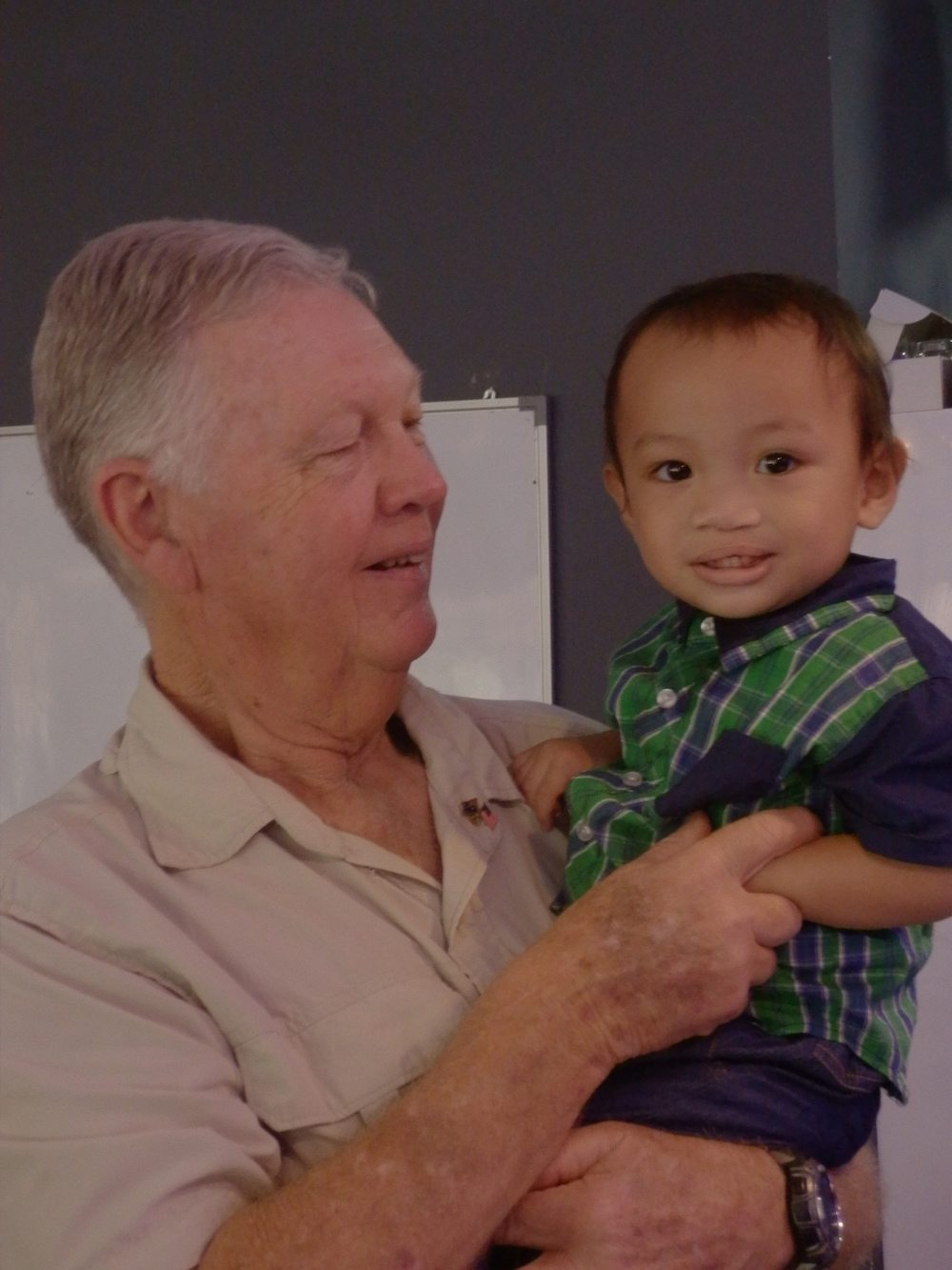 Sydney-based Neil Silver poses with a child who has undergone harelip and cleft palate surgery. — Picture courtesy of Lynette Silver