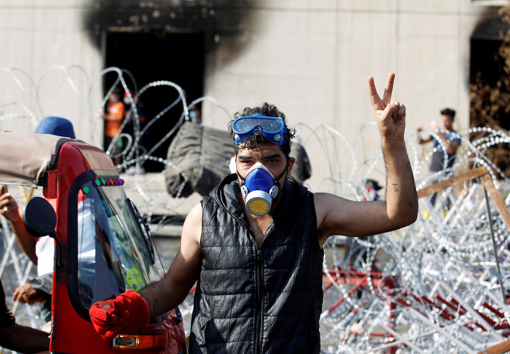 A demonstrator wears a mask to protect himself from tear gas during a protest over corruption, lack of jobs, and poor services, in Baghdad October 26, 2019. u00e2u20acu201d Reuters pic