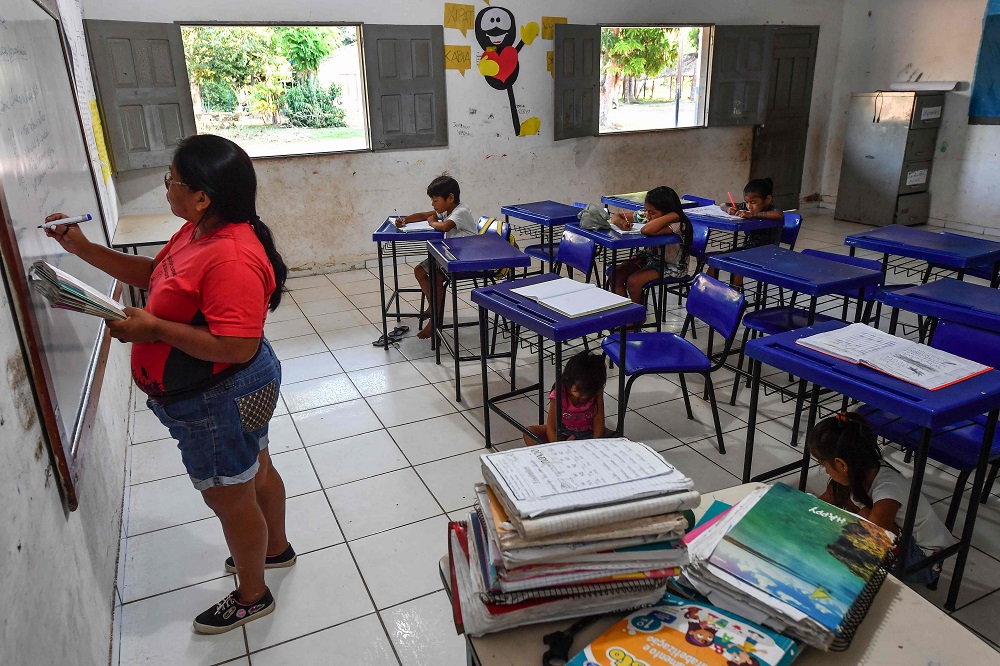 Munduruku indigenous teacher Claudeth Gabriel Sau Munduruku works at a school in Praia do Mangue indigenous reserve, in Itaituba, Para state, Brazil, in the Amazon rainforest September 10, 2019. u00e2u20acu2022 AFP pic  