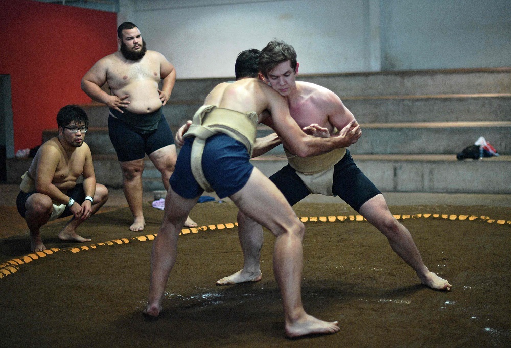 Brazil sumo wrestler Rui Junior (second from left, background) looks at his students during a practice session in Sao Paulo September 14, 2019. u00e2u20acu201d AFP pic