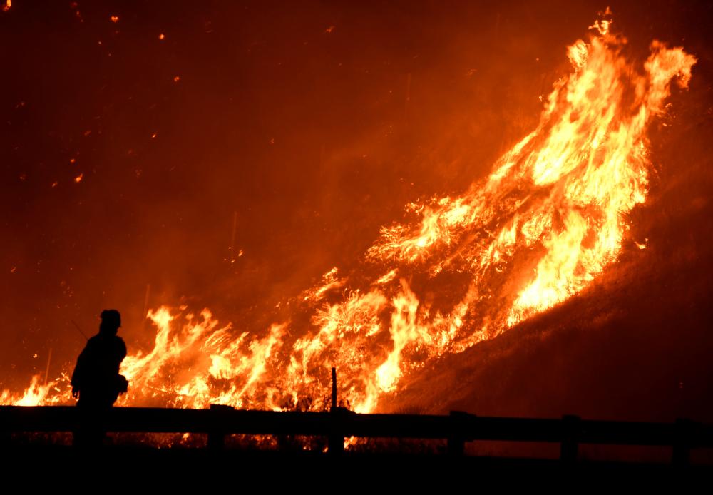 Firefighters battle a fire as a wind driven wildfire continues to burn in Canyon Country north of Los Angeles, California, October 25, 2019. u00e2u20acu2022 Reuters pic