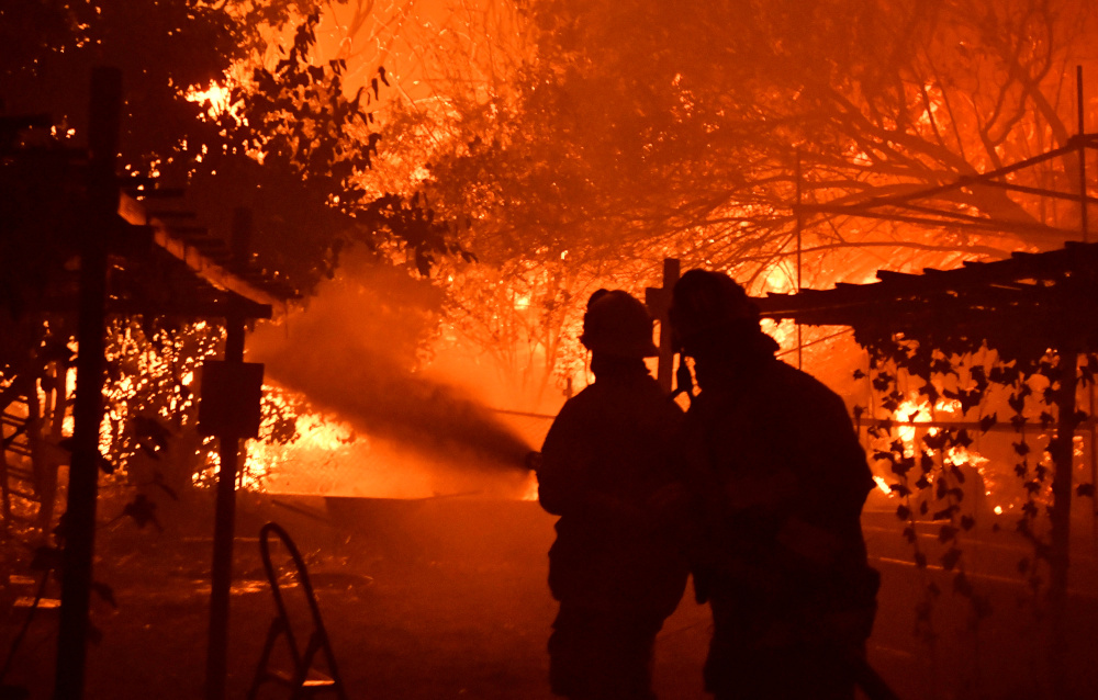 Firefighters battle a wind-driven wildfire called the Saddle Ridge fire in the early morning hours Friday in Porter Ranch, California, US, October 11, 2019. u00e2u20acu201d Reuters pic 