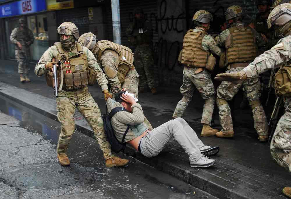 Security forces detain a demonstrator during anti-government protests, in Concepcion, Chile October 26, 2019. u00e2u20acu2022 Reuters pic