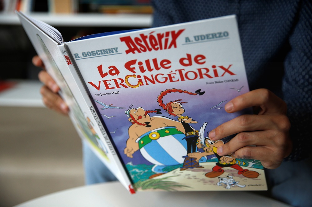 A journalist holds the new Asterix comic album named u00e2u20acu02dcLa Fille De Vercingetorixu00e2u20acu2122 (u00e2u20acu02dcAsterix and the Chieftainu00e2u20acu2122s Daughteru00e2u20acu2122) in Vanves near Paris October 22, 2019. u00e2u20acu201d Reuters pic  
