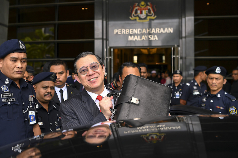 Finance Minister Lim Guan Eng holds up the briefcase with his Budget 2020 speech at the Finance Ministry in Putrajaya October 11, 2019. u00e2u20acu201d Bernama pic