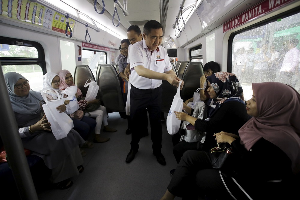 Transport Minister Anthony Loke hands out food packs to commuters during the official opening of the Nilai Komuter station in Nilai October 12, 2019. u00e2u20acu201d Bernama pic