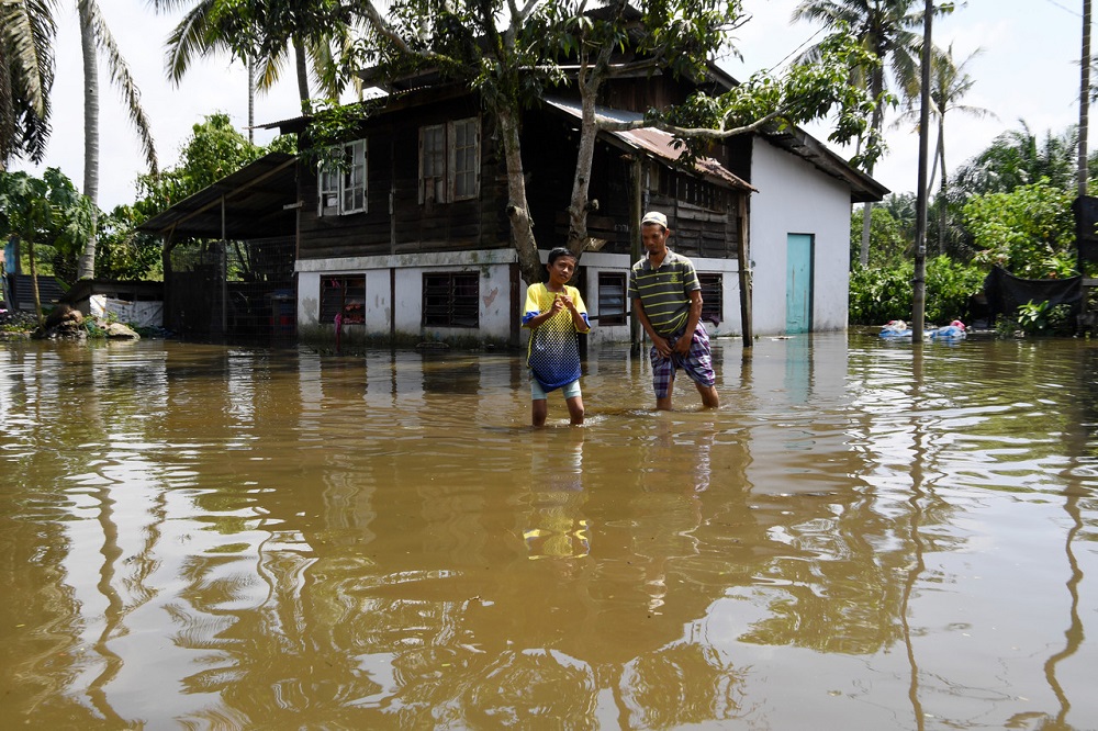 People are seen wading in flood water in Bukit Mertajam October 24, 2019. u00e2u20acu201d Bernama pic