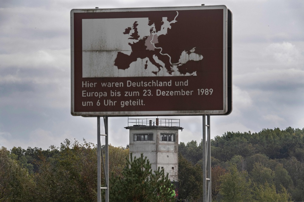 A sign reading: u00e2u20acu02dcHere, Germany and Europe were separated until the 23rd of December 1989, at 0600u00e2u20acu2122 stands next to an east German watchtower near Salzwedel, northern Germany, on the former border between east and west Germany October 8, 2019. u00e2u20acu201d AFP p
