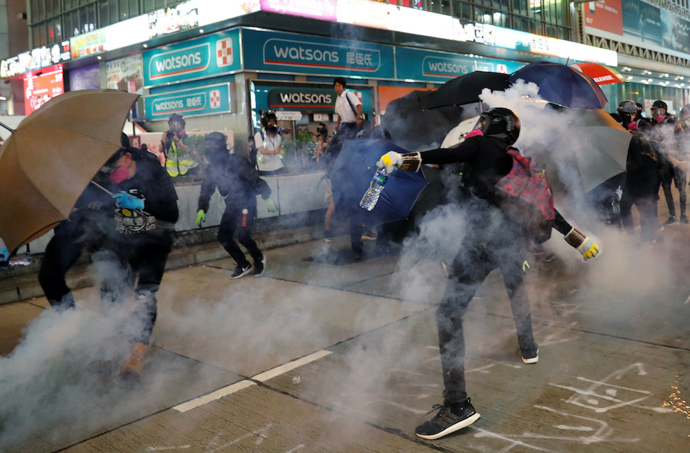 An anti-government throws a tear gas canister during a protest in Hong Kongu00e2u20acu2122s tourism district of Tsim Sha Tsui, China October 27, 2019. u00e2u20acu201d Reuters picnnn