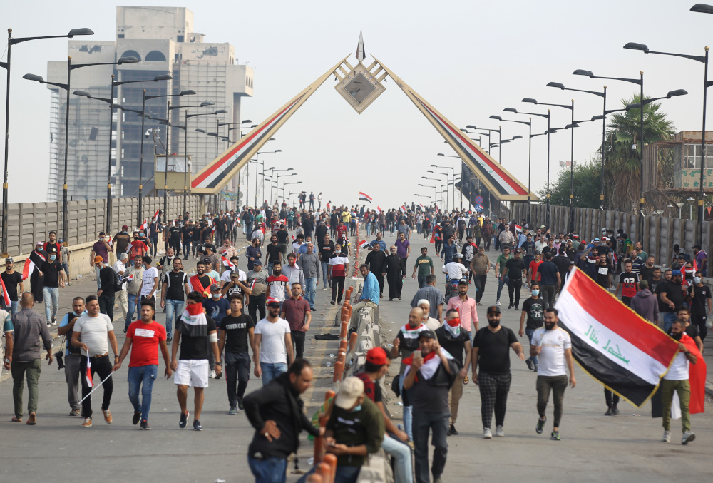 Iraqi protesters walk through Baghdadu00e2u20acu2122s Al-Jumhuriya Bridge towards the Green Zone during anti-government demonstrations in the Iraqi capital October 25, 2019. u00e2u20acu201d AFP pic 