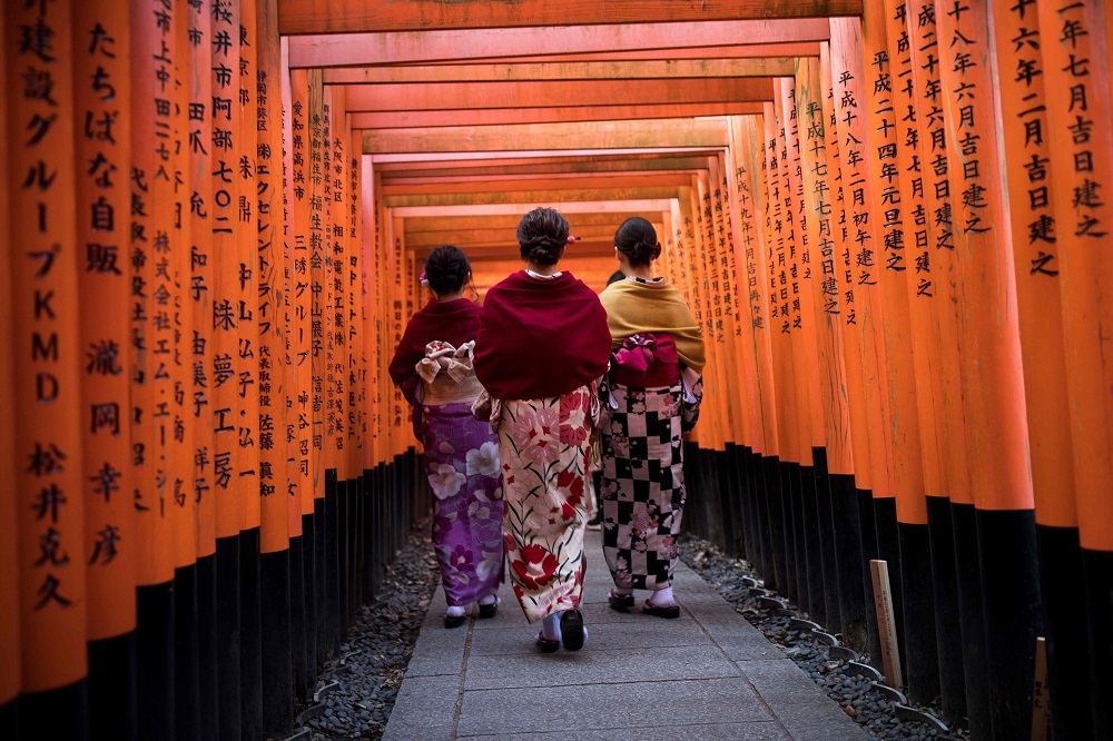 In this file photo taken on December 9, 2018, tourists wearing kimono walk through the torii gates at Fushimi Inari Shrine in Kyoto. u00e2u20acu201d AFP pic          