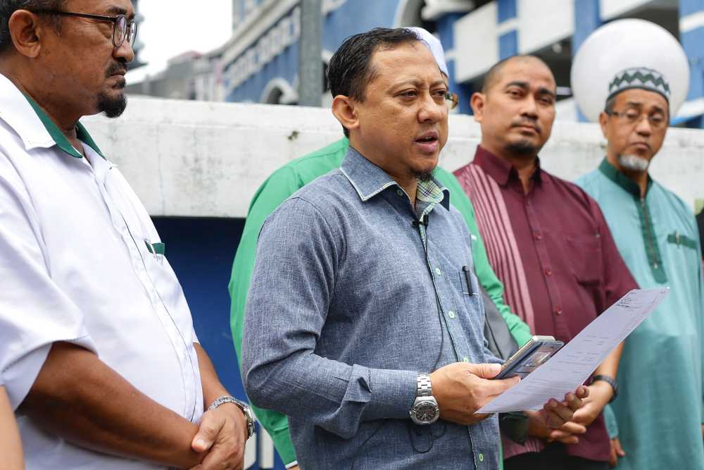 PAS Information Chief Kamaruzaman Mohamad speaks to reporters outside the Dang Wangi police station in Kuala Lumpur October 21, 2019. u00e2u20acu2022 Picture by Ahmad Zamzahuri