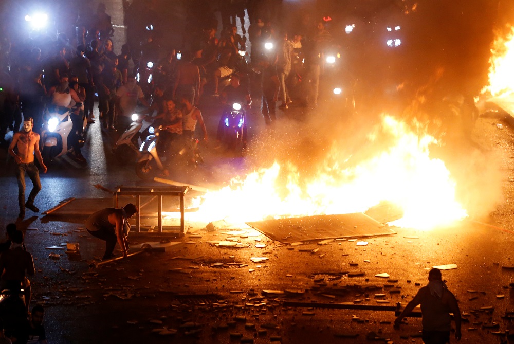 Demonstrators on motorbikes ride close to a fire during a protest over the deteriorating economic situation in Beirut, Lebanon October 18, 2019. u00e2u20acu201d Reuters pic