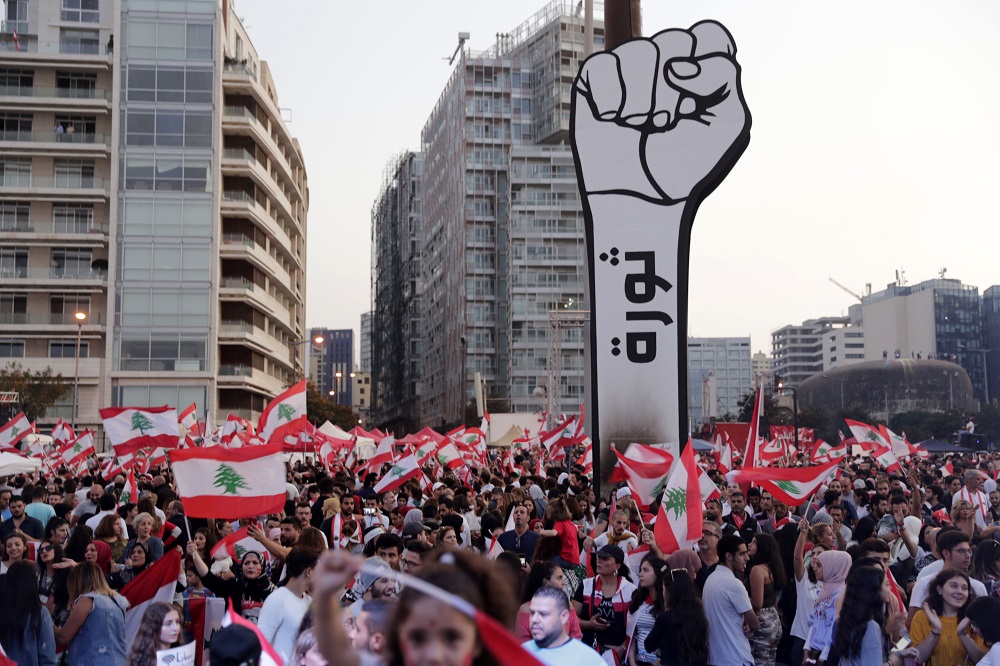 Lebanese demonstrators raise a large clenched fist with u00e2u20acu02dcrevolutionu00e2u20acu2122 written on it at the Martyrsu00e2u20acu2122 Square in the centre of the capital Beirut on October 27, 2019, during ongoing anti-government protests. u00e2u20acu201d AFP pic          