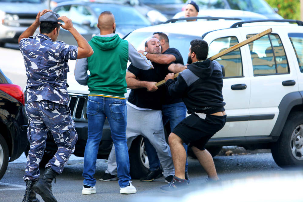 Supporters of Lebanese Shiu00e2u20acu2122ite groups Hezbollah and Amal scuffle with protesters at a roadblock on a main road in Beirut, during ongoing anti-government protest, Lebanon October 29, 2019. u00e2u20acu201d Reuters pic