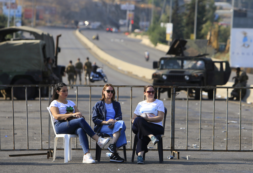 Demonstrators sit in front of a barricade blocking off a main road leading from southern Lebanon to Beirut, during a protest targeting the government over an economic crisis, at Barja area, Lebanon October 19, 2019. u00e2u20acu201d Reuters pic