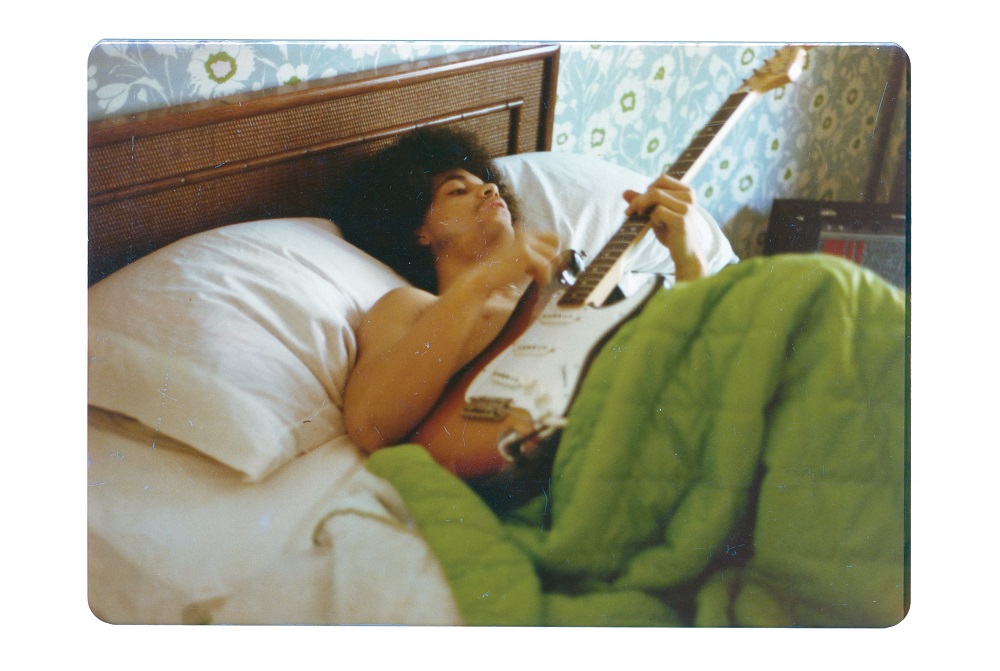 This undated photo courtesy of Penguin Random House shows musician Prince holding a guitar in bed.  u00e2u20acu201d Joe Giannetti/ Penguin Random House/AFP pic