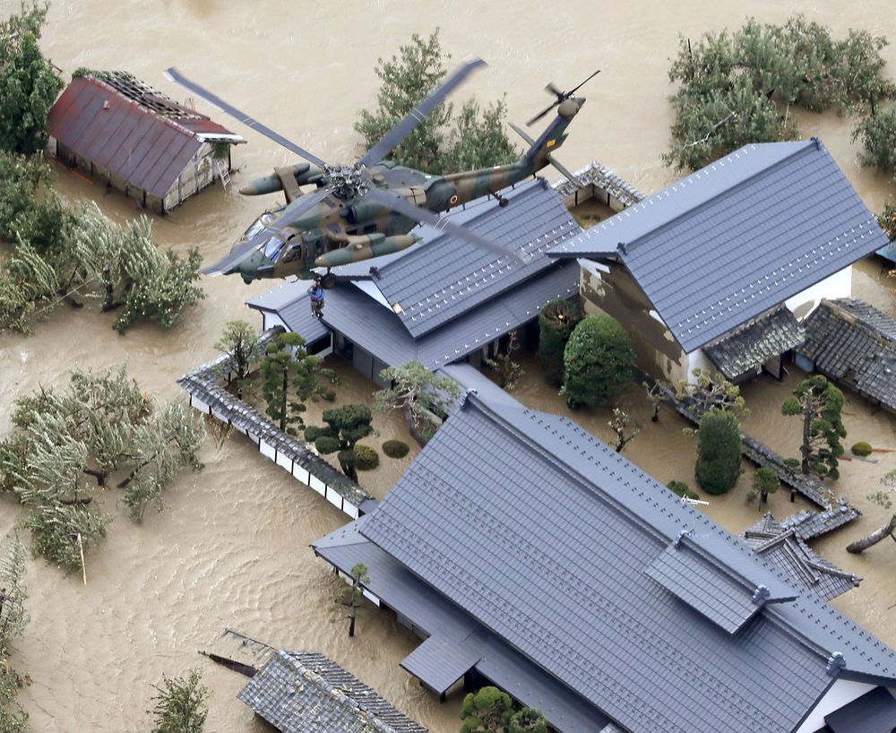 An aerial view shows a local resident is rescued by a Japan Self-Defence Force helicopter from residential areas flooded by the Chikuma river, caused by Typhoon Hagibis in Nagano, central Japan, October 13, 2019. u00e2u20acu201d Kyodo pic via Reuters