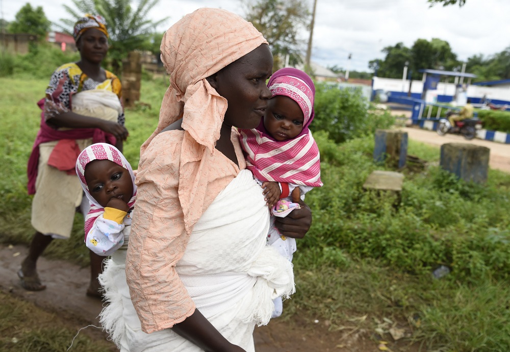 A mother carrying twins arrive to attend Igbo-Ora World Twins festival  to celebrate the uniqueness in multiple births at Igbo-Ora Town in Oyo State, southwest Nigeria October 12, 2019. — AFP pic  